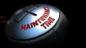 Gear Stick with Red Text Maintenance Time on Black Background. Close Up View. Selective Focus. Control Concept.